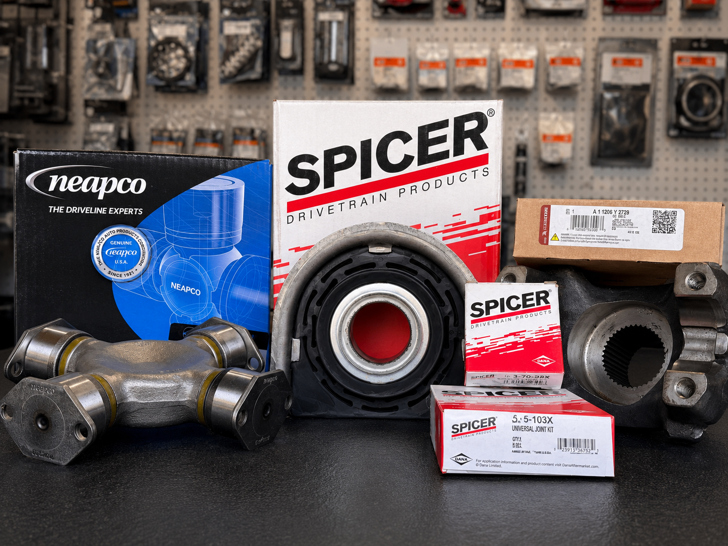 Heavy-duty truck driveline parts including U-joints, drive shafts, and yokes.